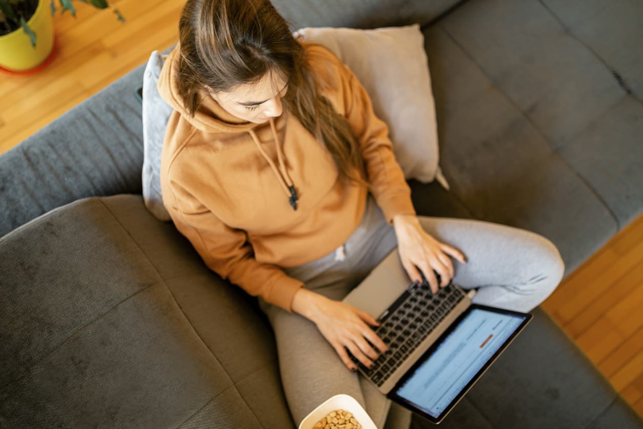 Young woman practicing online safety tips while working from home