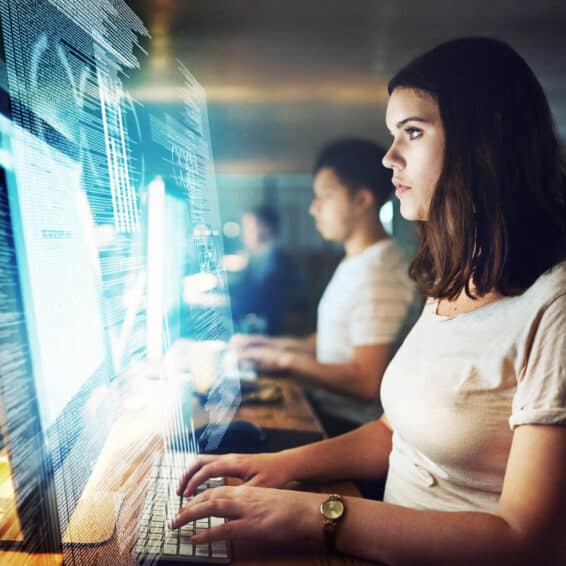 A group of fraud and risk mitigation employees performing research on their computers